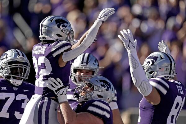 Kansas State running back Deuce Vaughn (22) celebrates with teammates after scoring a touchdown during the first half of an NCAA college football game against TCU, Saturday, Oct. 30, 2021, in Manhattan, Kan. (AP Photo/Charlie Riedel)