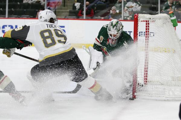 Minnesota Wild goaltender Cam Talbot (33) stops a shot by Vegas Golden Knights right wing Alex Tuch (89) during the second period in Game 6 of an NHL hockey Stanley Cup first-round playoff series Wednesday, May 26, 2021, in St. Paul, Minn. (AP Photo/Andy Clayton-King)