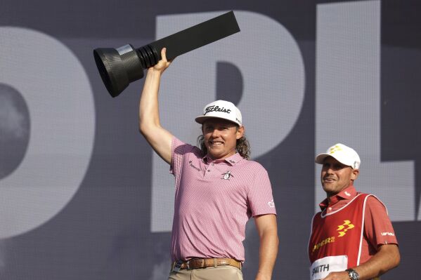 Rippers GC's Cameron Smith lifts the trophy following day three of the LIV Golf League at the Centurion Club, in Hertfordshire, England, Sunday July 9, 2023. (George Tewkesbury/PA via AP)