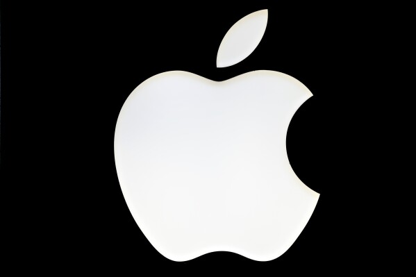 FILE - A logo of the Apple company is pictured in Berlin, Germany, Wednesday Jan. 4, 2017. Apple is opening small cracks in the iPhone's digital fortress as part of a regulatory clampdown in Europe that is striving to give consumers more choices — at the risk of creating new avenues for hackers to steal personal and financial information stored on the devices. (AP Photo/Michael Sohn, File)