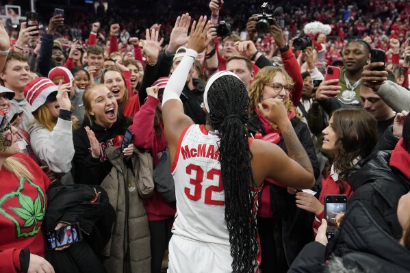 Ohio State's Cotie McMahon celebrates with fans after they defeated Iowa in overtime in an NCAA college basketball game, Sunday, Jan. 21, 2024, in Columbus, Ohio. (AP Photo/Sue Ogrocki)