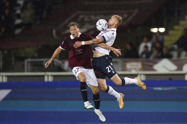 Torino's Mergim Vojvoda, left, and Bologna's Jens Odgaard battle for the ball during the Serie A soccer match between Torino and Bologna at the Olympic Stadium Grande Torino, Turin, Italy, Friday May 3, 2024. (Spada/LaPresse via AP)