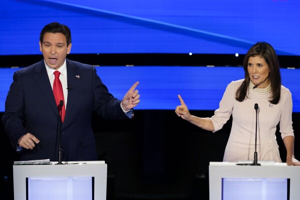 Former UN Ambassador Nikki Haley, right, and Florida Gov. Ron DeSantis, left, both speaking at the at the CNN Republican presidential debate at Drake University in Des Moines, Iowa, Wednesday, Jan. 10, 2024. (AP Photo/Andrew Harnik)