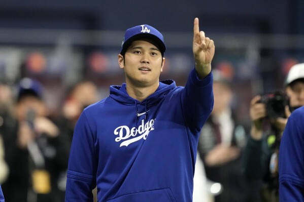 FILE - Los Angeles Dodgers designated hitter Shohei Ohtani gestures as he warms up during batting practice prior to an opening day baseball game at the Gocheok Sky Dome in Seoul, South Korea Wednesday, March 20, 2024, in Seoul, South Korea. The firing of Ohtani's interpreter by the Los Angeles Dodgers over allegations of illegal gambling has highlighted an issue many outside of California don't realize: Sports betting is still against the law in the nation's most populous state. (AP Photo/Lee Jin-man,File)