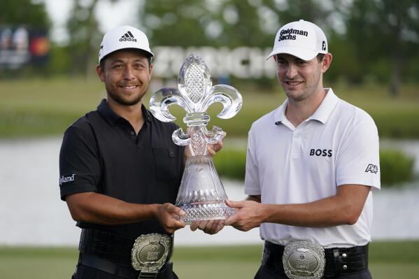 FILE - Xander Schauffele, left, and Patrick Cantlay, right, hold up the trophy after winning the PGA Zurich Classic golf tournament at TPC Louisiana in Avondale, La., Sunday, April 24, 2022. The Zurich Classic's unusual two-player team format has attracted a field featuring some of the PGA's most accomplished players -- even without the big purse of an elevated event. Defending champions Cantlay and Schauffele will be up against teams featuring former major winners, including Matt Fitzpatrick with his brother, Alex, and Colin Morikawa with Max Homa. (AP Photo/Gerald Herbert, File)