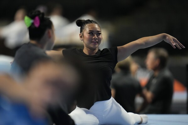 Suni Lee warms up at the U.S. Classic gymnastics competition Friday, Aug. 4, 2023, in Hoffman Estates, Ill. (AP Photo/Erin Hooley)