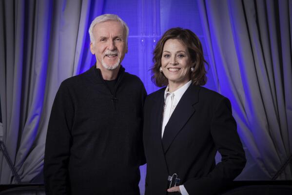 Director James Cameron, left, and Sigourney Weaver pose for a photo to promote the film "Avatar: The Way of Water" in London, Sunday, Dec. 4, 2022. (Photo by Vianney Le Caer/Invision/AP)