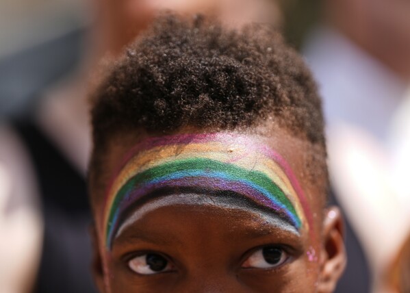 A child watches the World Pride parade, Saturday, June 7, 2025, in Washington. (AP Photo/Julia Demaree Nikhinson)