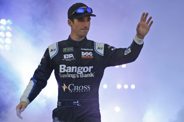Austin Theriault greets fans during driver introductions for the NASCAR Monster Energy Cup series auto race at Richmond Raceway in Richmond, Va., Sept. 21, 2019. The NASCAR driver-turned-politician wants the opportunity to challenge Democratic U.S. Rep. Jared Golden in Maine. Theriault, who made his announcement on a radio show, said he’ll “come in with fire” to confront issues like inflation, illegal border crossings and dying small towns. The 29-year-old freshman state lawmaker from Fort Kent formally filed his paperwork Monday, Sept. 25, 2023. (AP Photo/Steve Helber)
