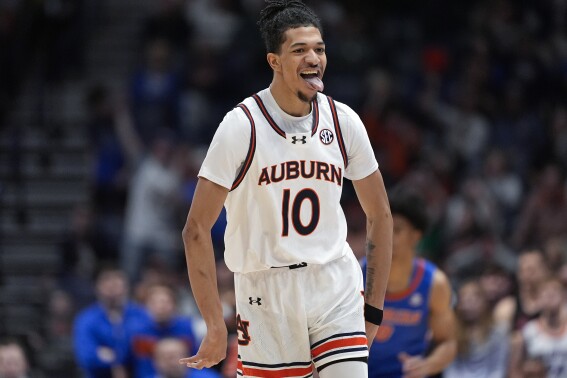 Auburn guard Chad Baker-Mazara (10) reacts after a basket in the first half of an NCAA college basketball game against Florida at the Southeastern Conference tournament Sunday, March 17, 2024, in Nashville, Tenn. (AP Photo/John Bazemore)