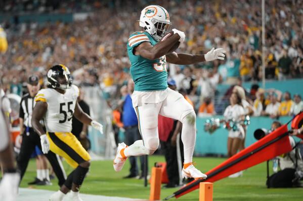 Miami Dolphins running back Raheem Mostert (31) scores a touchdown during the first half of an NFL football game against the Pittsburgh Steelers, Sunday, Oct. 23, 2022, in Miami Gardens, Fla. (AP Photo/Rebecca Blackwell)