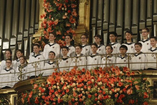 FILE - The Vienna Boys' Choir perform together with the Vienna Philharmonic Orchestra during the traditional New Year's concert at the golden hall of the Musikverein in Vienna, Austria, on Jan. 1, 2016. The Austrian government said Saturday Dec. 30, 2023 that it is giving the country's centuries-old Vienna Boys Choir 800,000 euros ($884,000) to help it out of severe financial difficulties. (AP Photo/Ronald Zak, File)