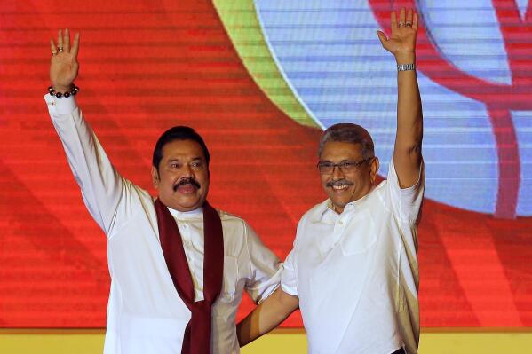 FILE - Mahinda Rajapaksa, left, and his brother Gotabaya Rajapaksa wave to supporters during a party convention held to announce the presidential candidacy in Colombo, Sri Lanka, Aug. 11, 2019. Sri Lanka’s main opposition party on Tuesday, May 3, 2022, issued a no-confidence declaration aiming at ousting Prime Minister Mahinda Rajapaksa and his Cabinet and blaming them of failing in their constitutional duty to provide a decent living standards amid the island nation's worst economic crisis in memory. (AP Photo/Eranga Jayawardena, File)