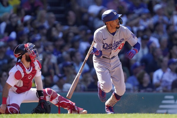 Los Angeles Dodgers' Mookie Betts, right, watches the flight of his two-run home run as Boston Red Sox catcher Connor Wong, left, looks on in the sixth inning of a baseball game, Sunday, Aug. 27, 2023, in Boston. (AP Photo/Steven Senne)