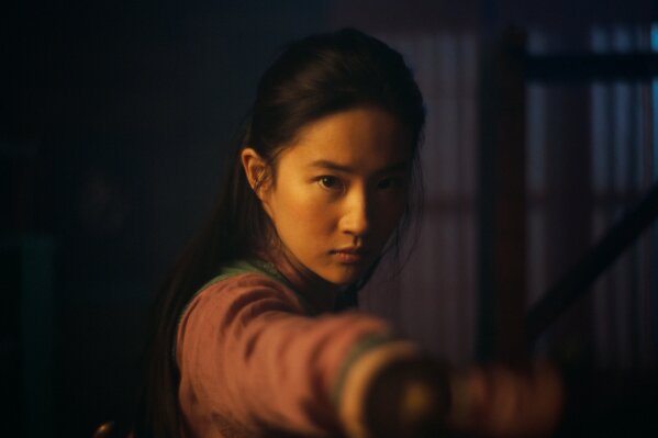 This image released by Disney shows Yifei Liu in the title role of "Mulan."  The film is no longer headed for a major theatrical release. The Walt Disney Co. said Tuesday that it will debut its live-action blockbuster on its subscription streaming service, Disney+, on Sept. 4. Customers will have to pay an additional $29.99 on top of the cost of the monthly subscription to rent “Mulan.” (Disney Enterprises, Inc. via AP)