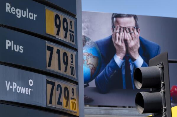 FILE - Gas prices are seen in front of a billboard advertising HBO's Last Week Tonight in Los Angeles, March 7, 2022. Three oil regimes that President Joe Biden and past U.S. leaders have snubbed — Venezuela, Saudi Arabia and Iran — are the targets of U.S. outreach as global fuel prices hit record highs during the Ukraine crisis. But it’s not clear any U.S. diplomacy could get more crude on the market fast enough to help the current supply crunch. (AP Photo/Jae C. Hong, File)