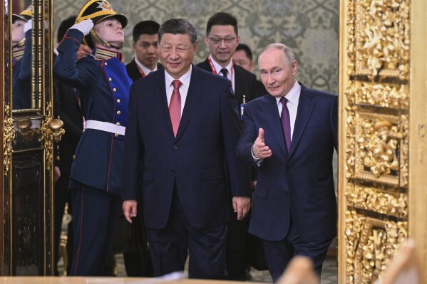 Russian President Vladimir Putin, right, and his Chinese counterpart Xi Jinping arrive for their talks at the Kremlin in Moscow, Russia, Thursday, May 8, 2025, ahead of celebrations of the 80th anniversary of the Soviet Union's victory over Nazi Germany during the World War II. (Alexei Danichev/Photo host agency RIA Novosti via AP)