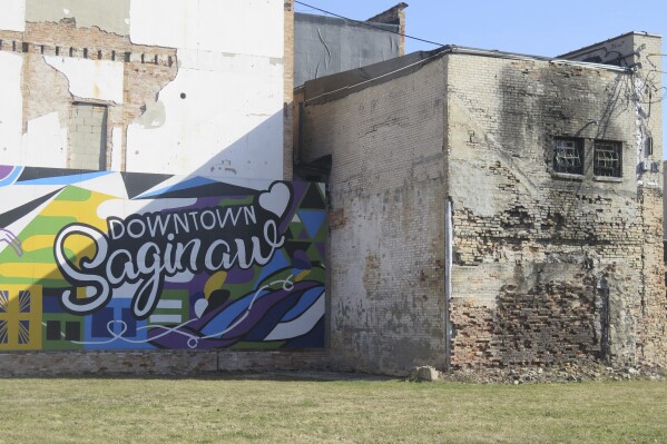 Afternoon sunshine hits parts of a mural in downtown Saginaw, Mich., Wednesday, March 12. The city's downtown has undergone mass transformation in the decades since it was one of the state's top automotive hubs. (AP Photo/Joey Cappelletti)