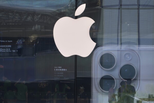 People visit an Apple store promoting its iPhone 16 at an outdoor shopping mall in Beijing, Sunday, May 11, 2025. (AP Photo/Andy Wong)