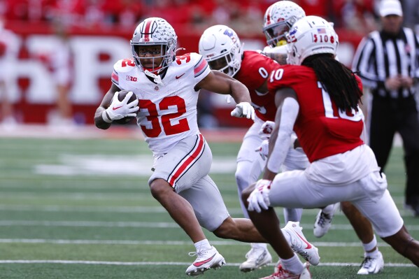Ohio State running back TreVeyon Henderson (32) rushes against Rutgers defensive back Flip Dixon (10) during the second half of a NCAA college football game, Saturday, Nov. 4, 2023, in Piscataway, N.J. Ohio State won 35-16. (AP Photo/Noah K. Murray)