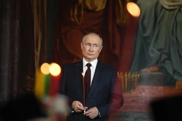 FILE - Russian President Vladimir Putin attends an Orthodox Easter service at the Cathedral of Christ the Savior in Moscow, Russia, Sunday, April 24, 2022.  The widow of Russian opposition leader Alexei Navalny has accused President Vladimir Putin of making a mockery of Christianity by trying to coerce her mother.  to agree to a secret funeral after his death in the penal colony.  (AP Photo/Alexander Zemlianichenko, Pond, File)