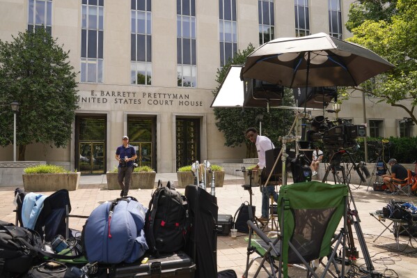 Members of the media outside E. Barrett Prettyman US Federal Courthouse, Wednesday, Aug. 2, 2023, in Washington. Former President Donald Trump is due in court on Thursday, the first step in a legal process that will play out in a courthouse between the White House he once controlled and the Capitol his supporters once stormed. (AP Photo/Pablo Martinez Monsivais)