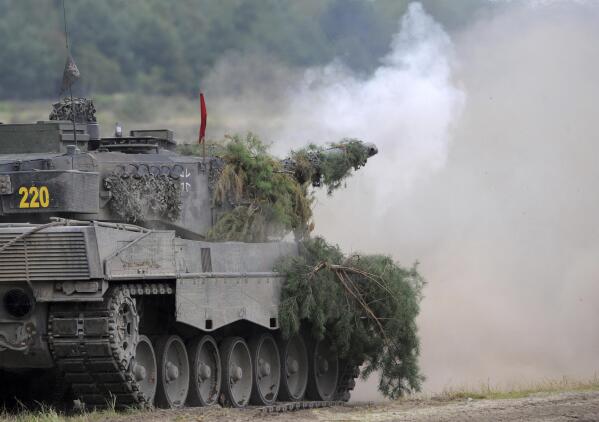 FILE -- A Leopard 2A6 tank from the Bundeswehr's Panzer exercise bataillon 93 fires at the Oberlausitz training area in Weisskeissel, Germany, Aug. 12, 2009. The German government has confirmed it will provide Ukraine with Leopard 2 battle tanks and approve requests by other countries to do the same. Chancellor Olaf Scholz said Wednesday that Germany was “acting in close coordination” with its allies. (Ralf Hirschberger/dpa via AP, file)