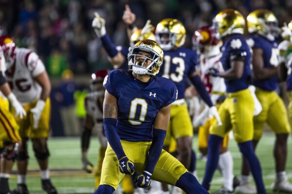 FILE - Notre Dame safety Xavier Watts (0) celebrates during the second half of an NCAA college football game against Southern California Saturday, Oct. 14, 2023, in South Bend, Ind. Watts has won the Bronko Nagurski Award given to the nation’s top defensive player, Monday, Dec. 4, 2023. (AP Photo/Michael Caterina, File)