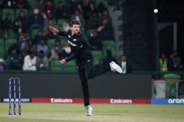 New Zealand's captain Mitchel Santner bowls a delivery during the ICC Champions Trophy semifinal cricket match between New Zealand and South Africa at Gaddafi Stadium in Lahore, Pakistan, Wednesday, March 5, 2025. (AP Photo/K.M Chaudary)
