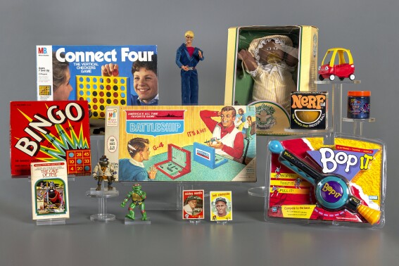 This photo provided by The Strong National Museum of Play in Rochester, N.Y., shows the 12 finalists being considered for induction into the National Toy Hall of Fame. The finalists, announced Wednesday, Sept. 13, 2023, are: baseball cards, Battleship, bingo, Bop It, Cabbage Patch Kids, Choose Your Own Adventure gamebooks, Connect 4, Ken, Little Tykes Cozy Coupe, Nerf, slime and Teenage Mutant Ninja Turtles. The Class of 2023 will be inducted Nov. 9. (The Strong National Museum of Play via AP)