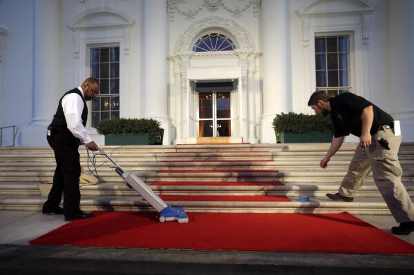 The red carpet is installed and cleaned by White House Staff as final preparations are made in preparation for the arrival of French President Francois Hollande at the North Portico of the White House in Washington, Tuesday, Feb. 11, 2014, for the State Dinner. (AP Photo/Pablo Martinez Monsivais)