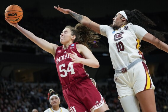 Indiana forward Mackenzie Holmes (54) puts up a shot against South Carolina center Kamilla Cardoso (10) during the second half of a Sweet Sixteen round college basketball game during the NCAA Tournament, Friday, March 29, 2024, in Albany, N.Y. (AP Photo/Mary Altaffer)
