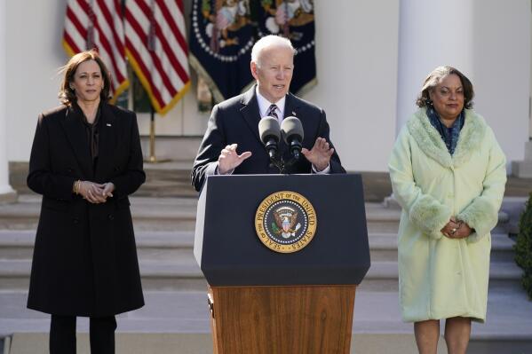 President Joe Biden speaks after signing the Emmett Till Anti-Lynching Act in the Rose Garden of the White House, Tuesday, March 29, 2022, in Washington. Vice President Kamala Harris, left, and Michelle Duster, great-granddaughter of civil rights pioneer Ida B. Wells look on. (AP Photo/Patrick Semansky)