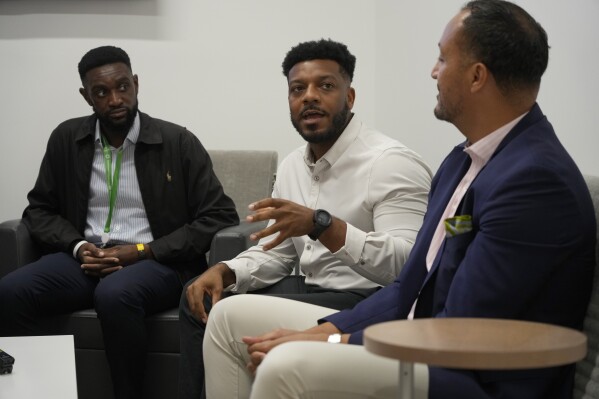 Meharry Medical College students Samuel Ademisoye, left, and Austin Brown, center, take part in a discussion with Michael Clay, Director of Family Services, right, at the Tennessee Donor Services headquarters June 16, 2023, in Nashville, Tenn. Brown of Memphis says his grandfather “absolutely despised medicine," and died of a heart attack after refusing an artery-clearing stent. (AP Photo/Mark Humphrey)