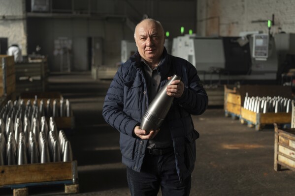 Anatolli Kuzmin, the factory’s 64-year-old owner, holds a mortar shell at a factory in Ukraine, on Wednesday, January 31, 2024. (AP Photo/Evgeniy Maloletka)