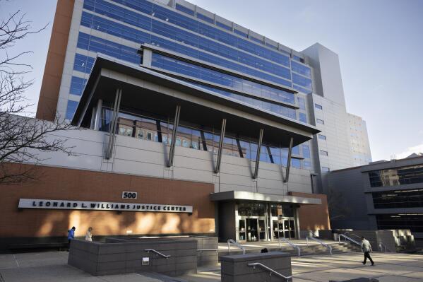 People walk by the Leonard L. Williams Justice Center in Wilmington, Del., Monday, Nov. 14, 2022. Testimony is under way in a shareholder lawsuit challenging approval by Tesla’s board of directors of a compensation plan potentially worth more than $55 billion for CEO Elon Musk. (AP Photo/Ryan Collerd)