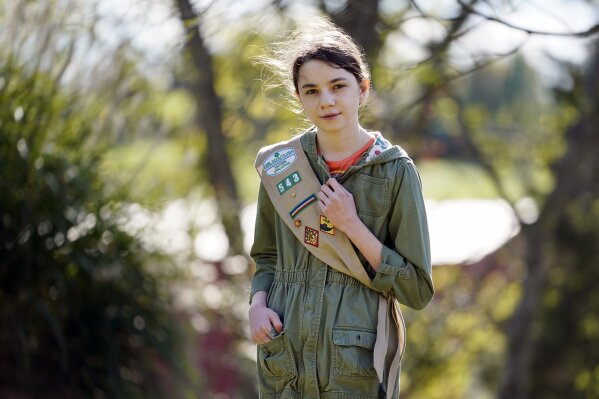 Olivia Chaffin, 14, stands for a portrait with her Girl Scout sash in Jonesborough, Tenn., on Sunday, Nov. 1, 2020. Olivia is asking Girl Scouts across the country to band with her and stop selling cookies, saying, "The cookies deceive a lot of people. They think it's sustainable, but it isn't." (AP Photo/Mark Humphrey)
