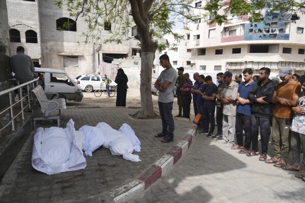 Palestinians pray over the bodies of victims of an Israeli army strike on a house belonging to the Jabr family during their funeral outside the al-Shifa hospital in Gaza City, Sunday, May 18, 2025. (AP Photo/Jehad Alshrafi)