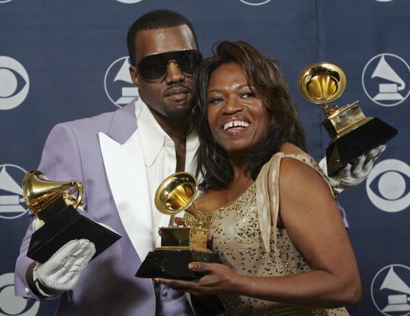 FILE - In this Feb. 8, 2006, file photo, Kanye West and his mother, Donda, hold his three awards backstage at the 48th Annual Grammy Awards in Los Angeles. West won for best rap album, solo and song. Kanye West unveiled his 10th studio album, “Donda,” in front of a packed crowd in Atlanta. His album was named after his mother, who died at the age of 58 following plastic surgery complications in 2007. (AP Photo/Reed Saxon, File)