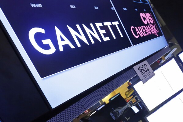 FILE - The Gannett logo appears on a monitor at the New York Stock Exchange on August 5, 2014. The media company Gannett denied that it published material created by artificial intelligence on a shopping website that it owns. But the company acknowledged that some material from third-party freelancers that appeared last week on the Reviewed site did not meet its editorial standards. (AP Photo/Richard Drew, File)