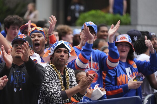 New York Knicks fans enjoy the New York Block Party outside Madison Square Garden before Game 6 in the Eastern Conference semifinals of the NBA basketball playoffs between the New York Knicks and the Boston Celtics Friday, May 16, 2025, in New York. (AP Photo/Frank Franklin II)