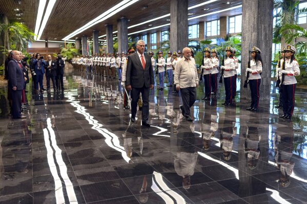 Cuban President Miguel Diaz-Canel, left, accompanies Brazilian President Luiz Inacio Lula da Silva during a visit to Revolution Palace, in Havana, Cuba, Saturday, Sept. 16, 2023. Lula is in Havana for the G77 + China summit. (AP Photo/Ramon Espinosa)