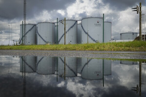 Vesta Terminals holding oil is reflected in Tallinn, Estonia, Wednesday, Oct. 4, 2023. Mercuria, part owner in Vesta Terminals, which operates storage terminals that hold crude oil, petroleum products and other liquids, sent six people to the COP in Egypt. (AP Photo/Sergei Grits)