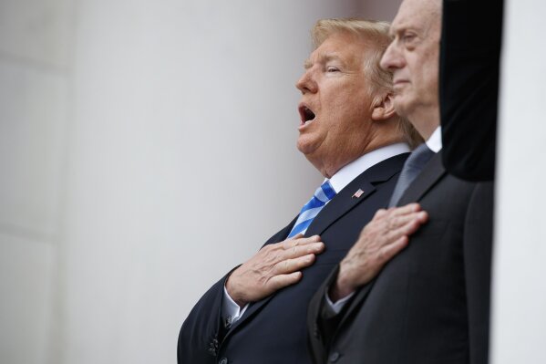 
              President Donald Trump sings the national anthem during a Memorial Day ceremony at Arlington National Cemetery, Monday, May 28, 2018, in Arlington, Va., with Defense Secretary Jim Mattis/ (AP Photo/Evan Vucci)
            