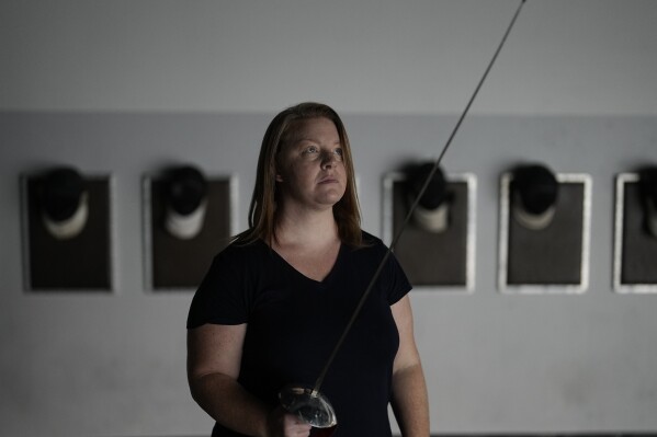 Fencer Kirsten Hawkes poses for a portrait at a fencing studio Tuesday, Sept. 12, 2023, in San Diego. (AP Photo/Gregory Bull)