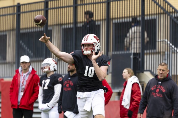 FILE - Wisconsin quarterback Tyler Van Dyke (10) throws a pass during spring NCAA college football practice in Madison, Wis., Saturday, April 20, 2024. (Samantha Madar/Wisconsin State Journal via AP, File)