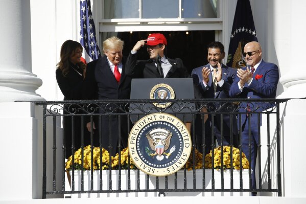 President Donald Trump, left, reacts as Washington Nationals catcher Kurt  Suzuki walks to a podium to speak during an event to honor the 2019 World  Series champion Nationals at the White House