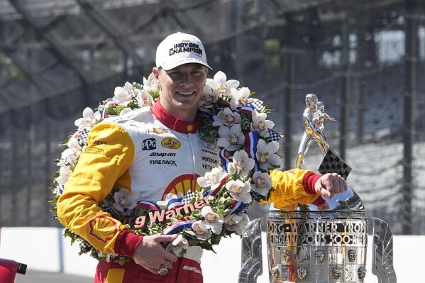 Josef Newgarden poses with the Borg-Warner Trophy during the traditional winners photo session at Indianapolis Motor Speedway, Monday, May 29, 2023, in Indianapolis. Newgarden won the 107th running of the Indianapolis 500 auto race Sunday. (AP Photo/Darron Cummings)