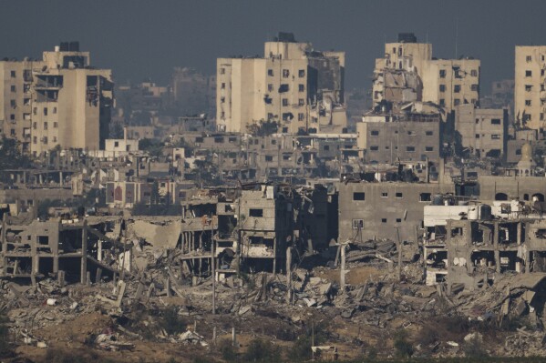 Destroyed buildings stand in the Gaza Strip, as seen from southern Israel, Thursday, Nov. 16, 2023. (AP Photo/Leo Correa)