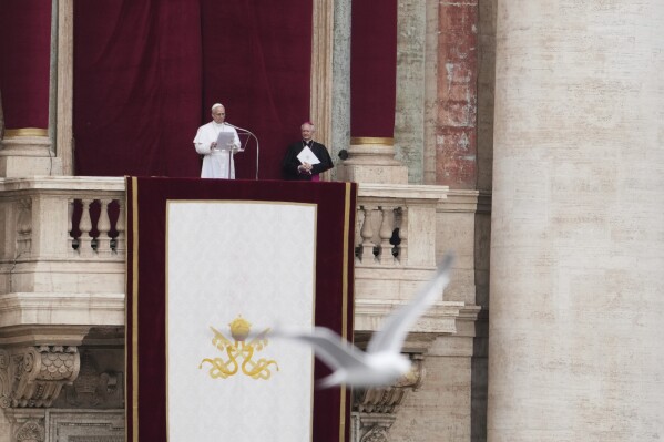 Pope Leo XIV appears at the central balcony of St. Peter's Basilica for his first Sunday blessing after his election, in St. Peter¥s Square at the Vatican, Sunday May 11, 2025. (AP Photo/Alessandra Tarantino)